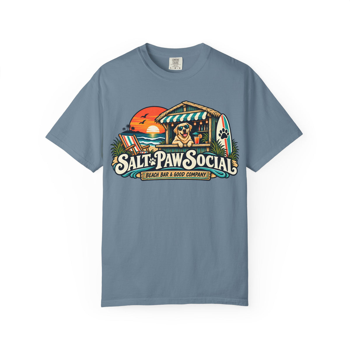 Brinehound T-shirt showing Salt Paw Social beach bar scene with a Labrador, surfboard and sunset.