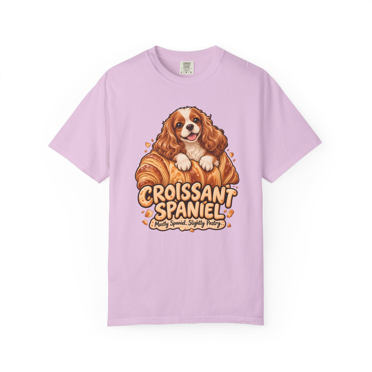 Orchid purple Croissant Spaniel T-shirt, featuring a Cavalier spaniel combined with a golden croissant and the wording “Croissant Spaniel — Mostly Spaniel. Slightly Pastry.”