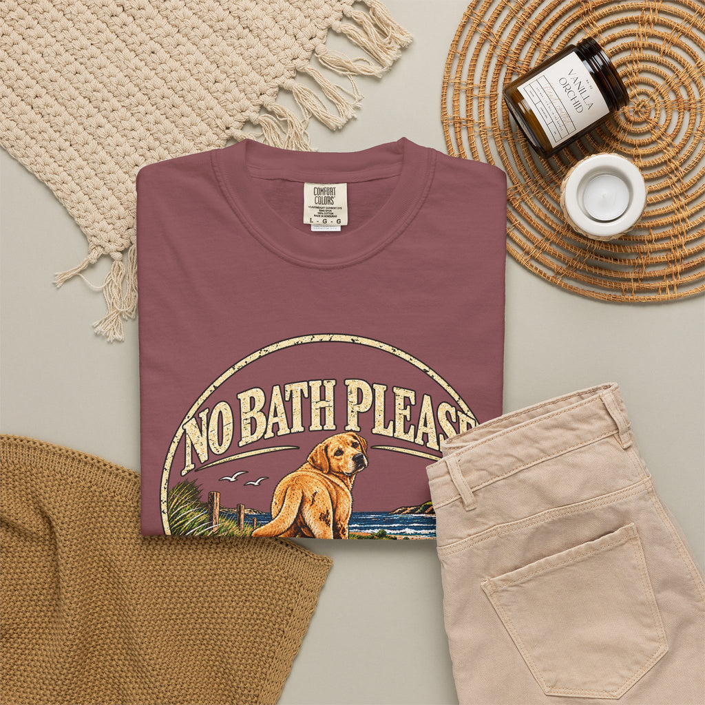 Flat-lay Brinehound T-shirt mockup showing dog in a No Bath Please coastal badge.