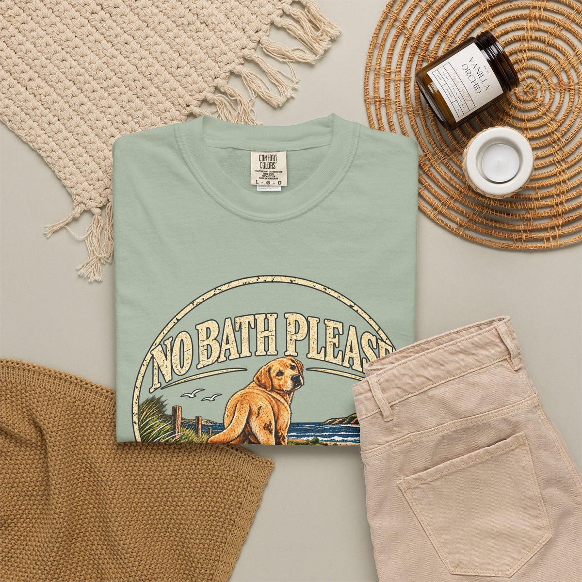 Flat-lay Brinehound T-shirt mockup showing dog in a No Bath Please coastal badge.
