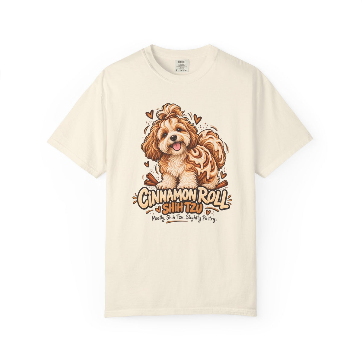 Ivory Cinnamon Roll Shih Tzu T-shirt, featuring a shaggy Shih Tzu combined with a cinnamon pastry swirl and the wording “Cinnamon Roll Shih Tzu — Mostly Shih Tzu. Slightly Pastry.”