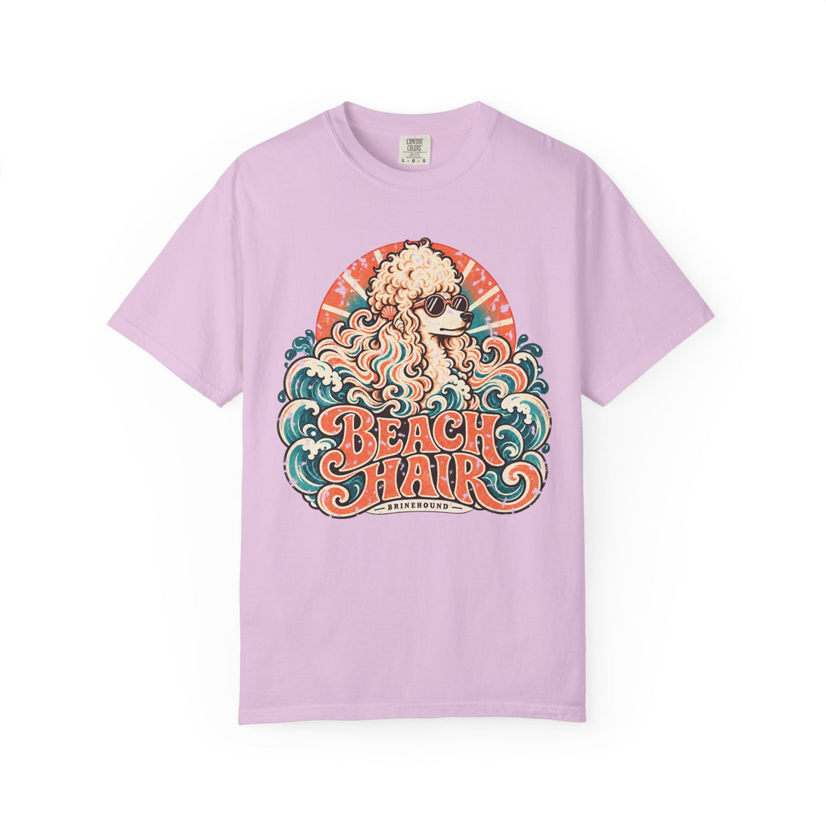 Front of a Orchid T-shirt featuring cream poodle in sunglasses, waves and “Beach Hair” lettering.