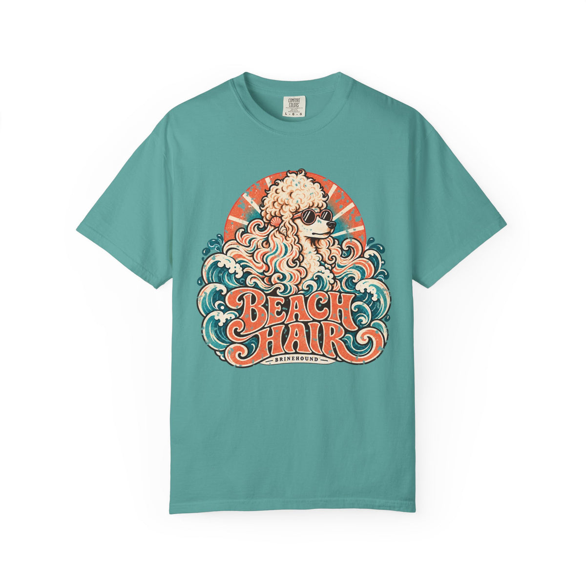 Front of a Seafoam T-shirt featuring cream poodle in sunglasses, waves and “Beach Hair” lettering.