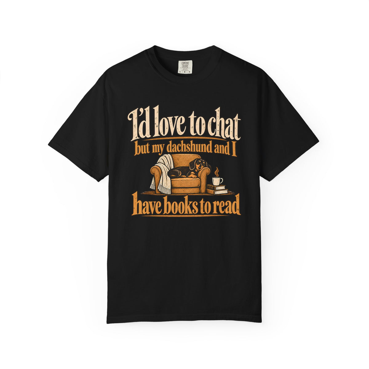 Front of a Black T-shirt with the dachshund, armchair and books illustration with “I’d love to chat” lettering.