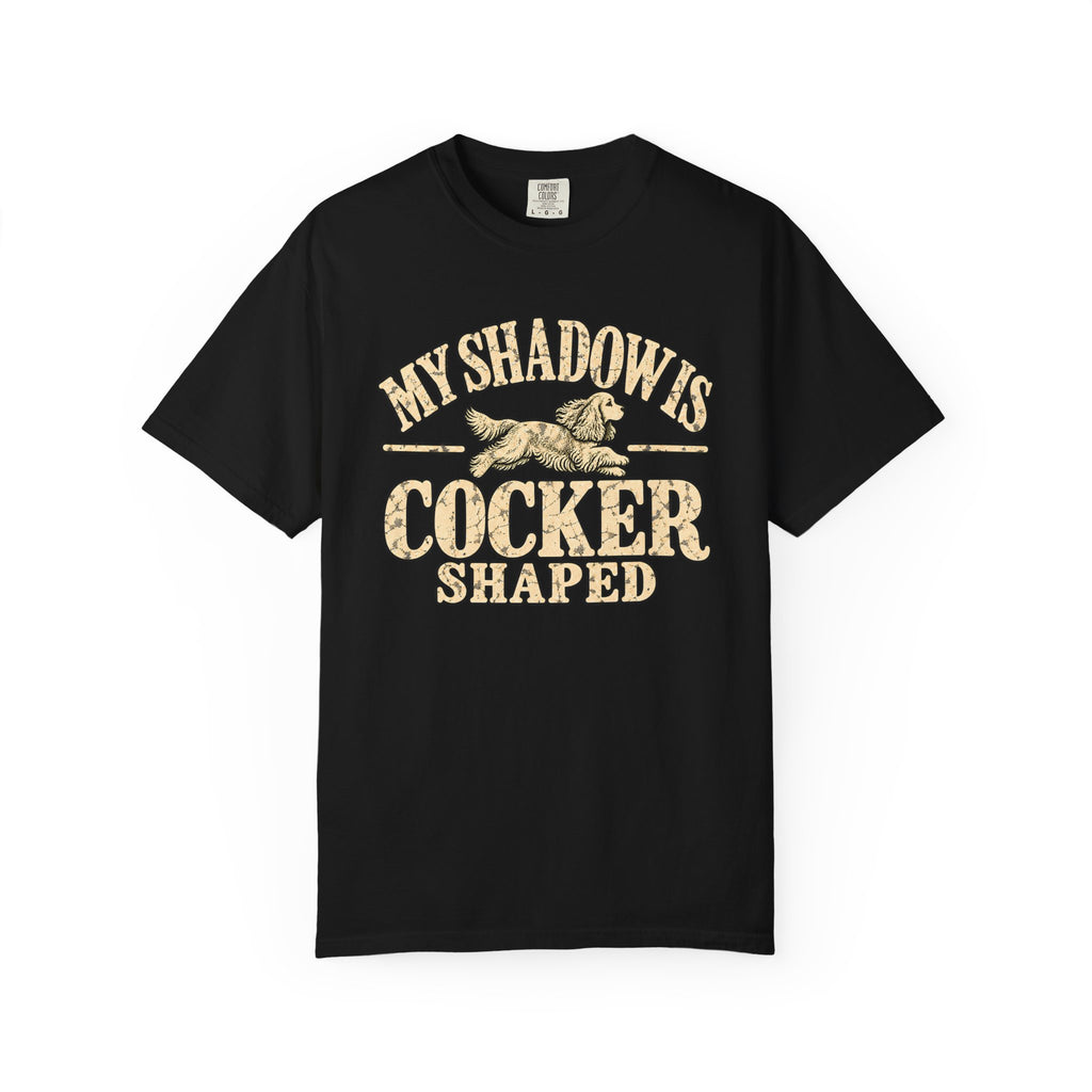 Front of a dark T-shirt with the Cocker Spaniel illustration and “My shadow is cocker shaped” lettering.