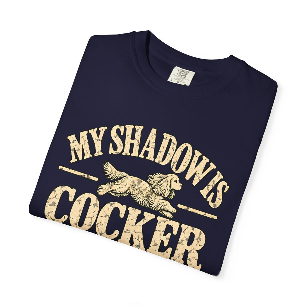 Folded True Navy T-shirt showing the Cocker Spaniel illustration and “My shadow is cocker shaped” lettering.
