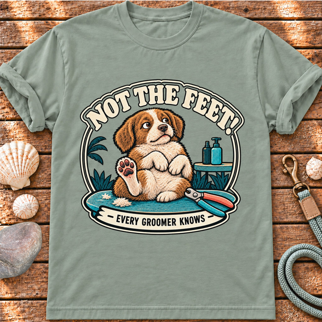 Front view of a Brinehound T-shirt showing a dog on a grooming table beneath Not the Feet lettering.