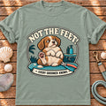Front view of a Brinehound T-shirt showing a dog on a grooming table beneath Not the Feet lettering.