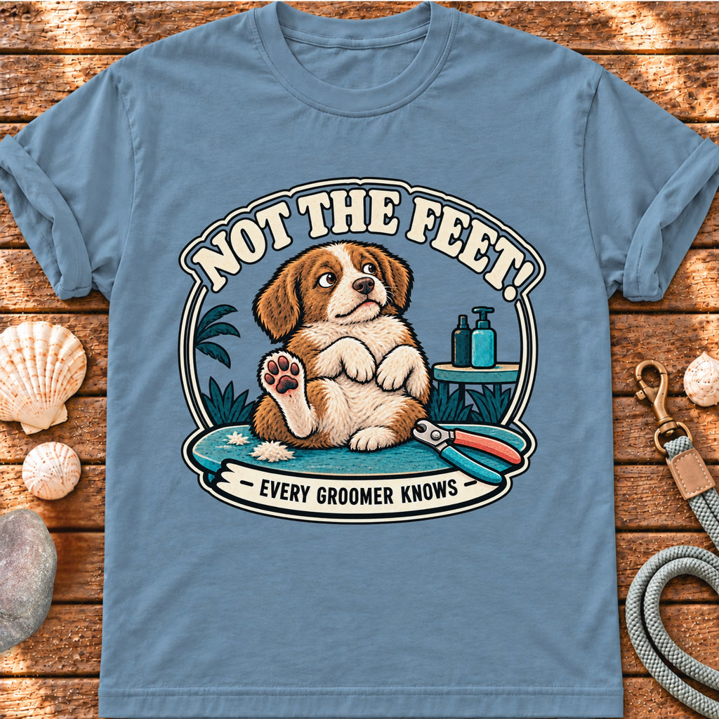 Front view of a Brinehound T-shirt showing a dog on a grooming table beneath Not the Feet lettering.