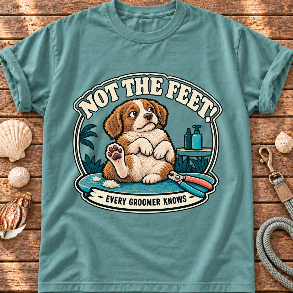 Front view of a Brinehound T-shirt showing a dog on a grooming table beneath Not the Feet lettering.