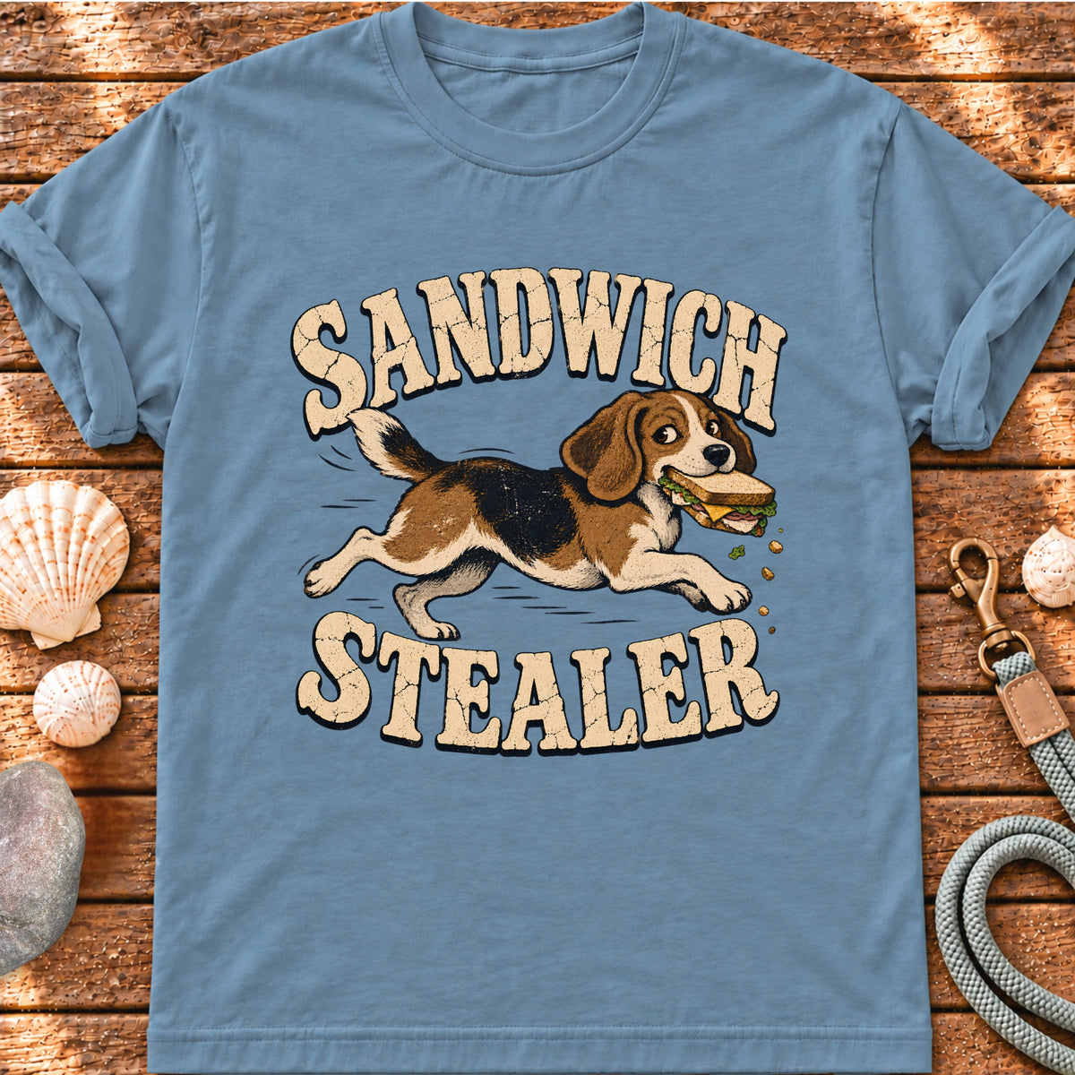 Front view of a Brinehound T-shirt showing a dog running with a stolen sandwich beneath Sandwich Stealer lettering.