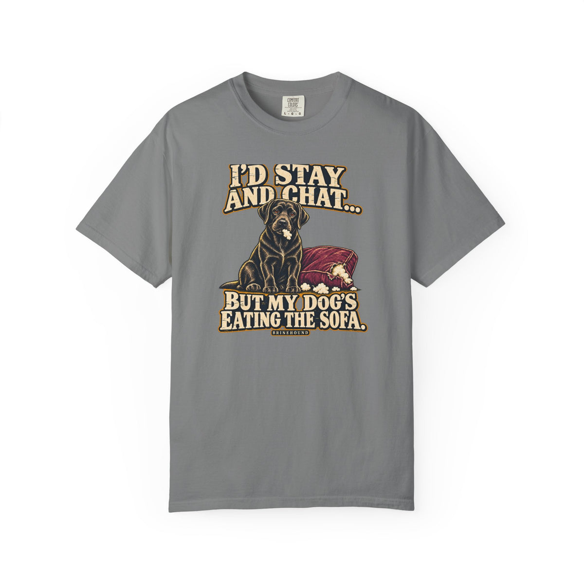 Front of a Grey T-shirt with a vintage black Labrador beside a chewed sofa and “I’d stay and chat” lettering print.