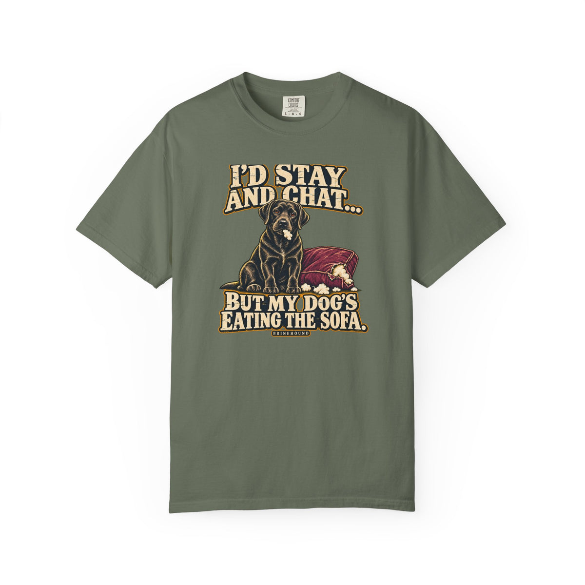 Front of a Moss T-shirt with a vintage black Labrador beside a chewed sofa and “I’d stay and chat” lettering print.