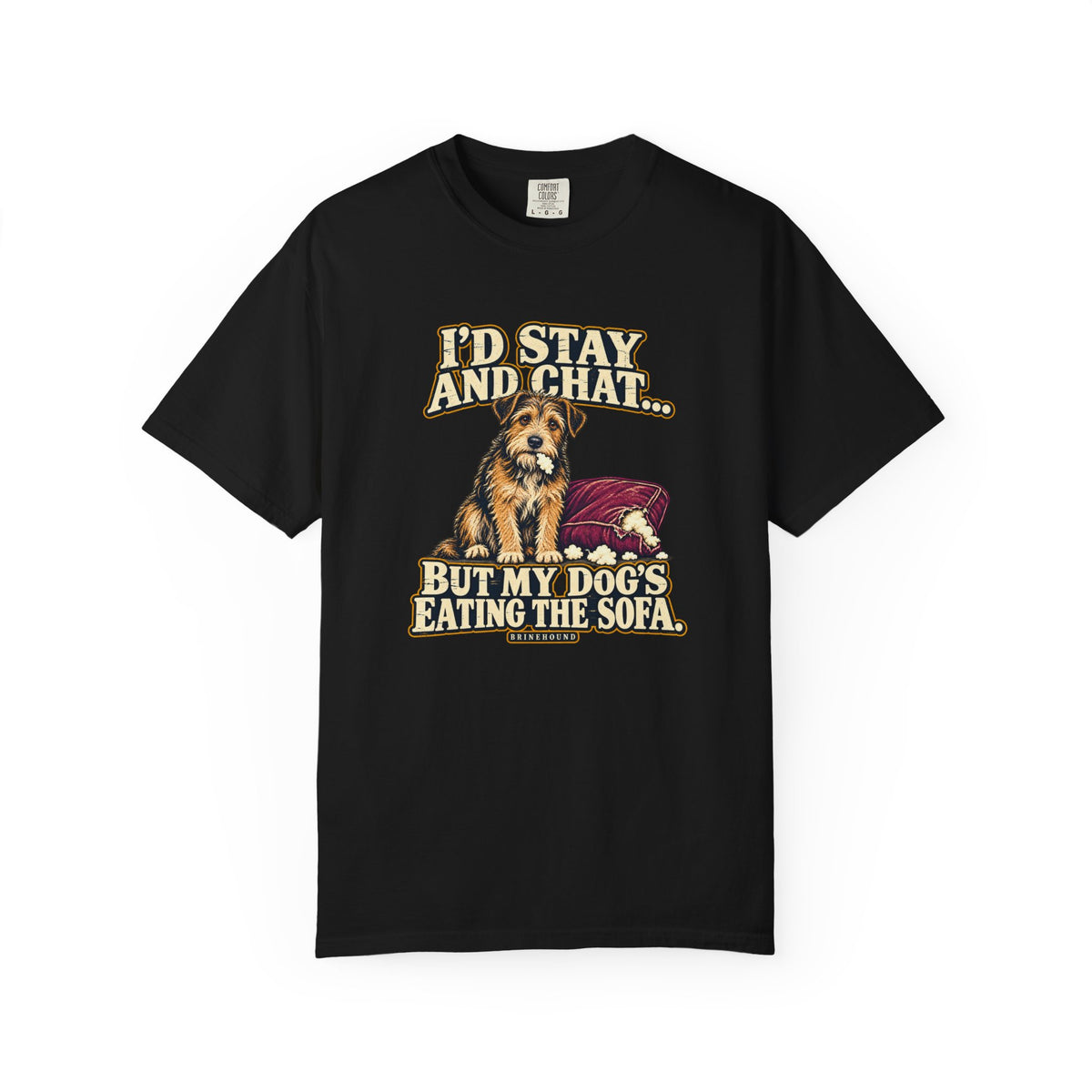 Front of a Black T-shirt with a vintage scruffy terrier beside a chewed sofa and “I’d stay and chat” lettering print.