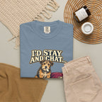 Ice Blue T-shirt with the scruffy terrier beside a chewed sofa and “I’d stay and chat” lettering print, styled with beige trousers and coffee.