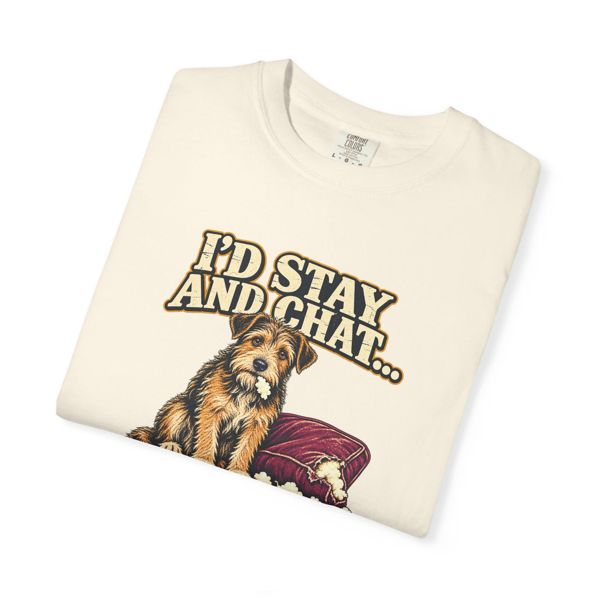 Folded Ivory T-shirt showing a close-up of the scruffy terrier beside a chewed sofa and “I’d stay and chat” lettering print.