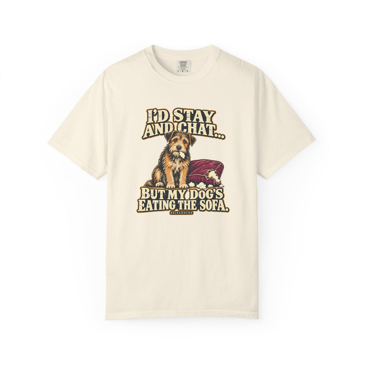 Front of a Ivory T-shirt with a vintage scruffy terrier beside a chewed sofa and “I’d stay and chat” lettering print.
