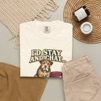 Ivory T-shirt with the scruffy terrier beside a chewed sofa and “I’d stay and chat” lettering print, styled with beige trousers and coffee.