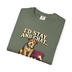 Folded Moss T-shirt showing a close-up of the scruffy terrier beside a chewed sofa and “I’d stay and chat” lettering print.