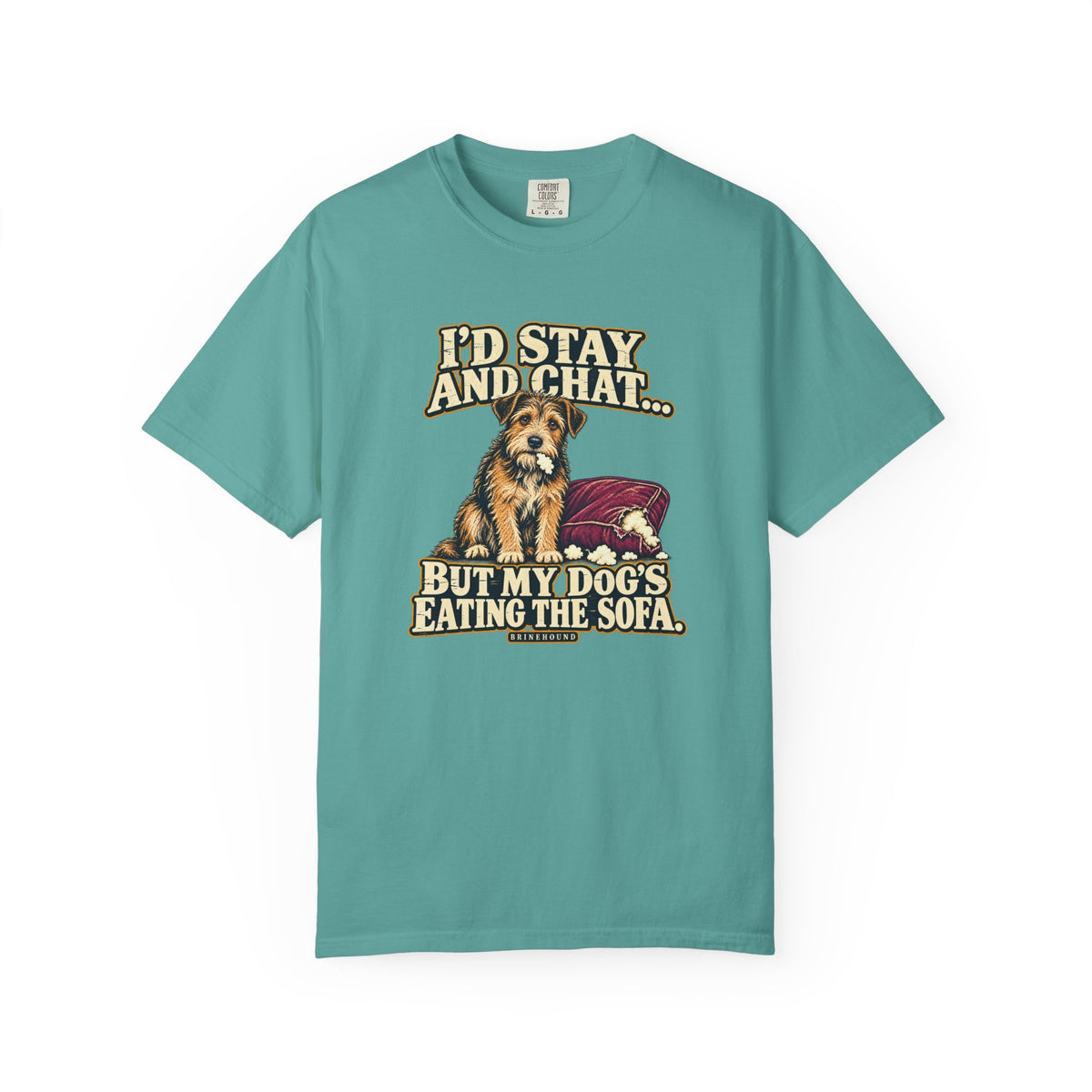Front of a Seafoam T-shirt with a vintage scruffy terrier beside a chewed sofa and “I’d stay and chat” lettering print.